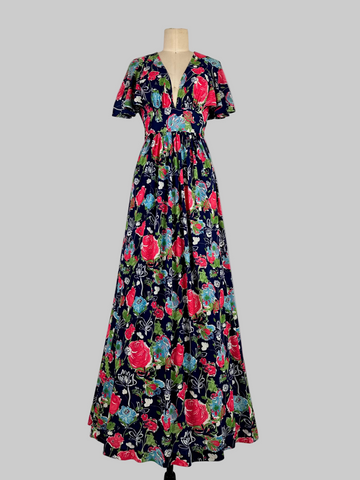 Vintage 1970s Jody T California floral print maxi dress featuring a vibrant, bohemian-inspired design with bold floral patterns, flowing silhouette, and retro charm