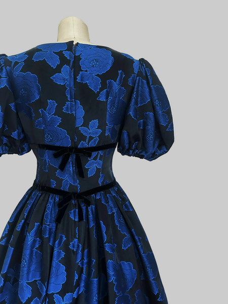 Back view of S.G. Gilbert vintage 1980s black and blue rose jacquard party dress with puff sleeves