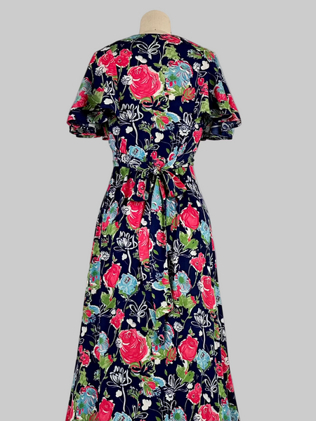 Vintage 1970s Jody T California floral print maxi dress featuring a vibrant, bohemian-inspired design with bold floral patterns, flowing silhouette, and retro charm