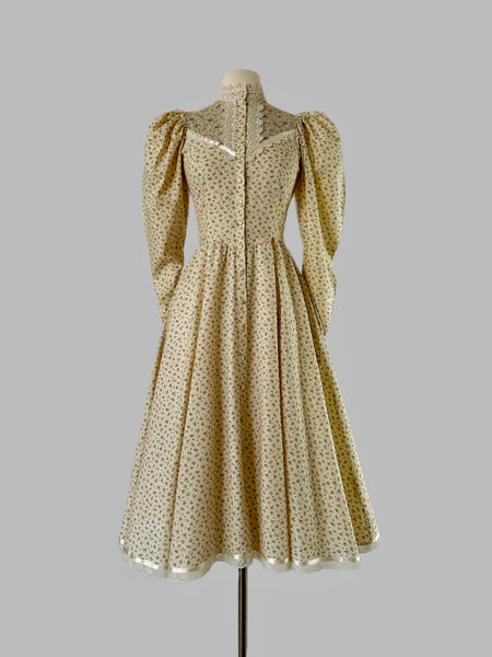 1970s Gunne Sax prairie dress with floral print, high lace collar, button-down front, and dramatic leg-of-mutton puffed sleeves