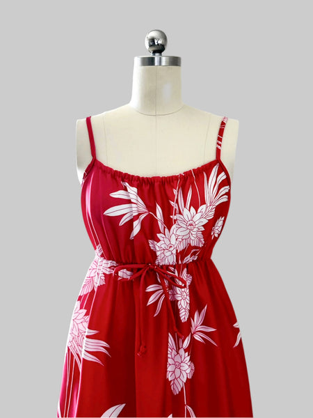 Vintage 1970s / 1980s red dress with large white tropical floral print, spaghetti straps, and an elasticized empire waist with tie detail; maxi length with soft, flowing drape