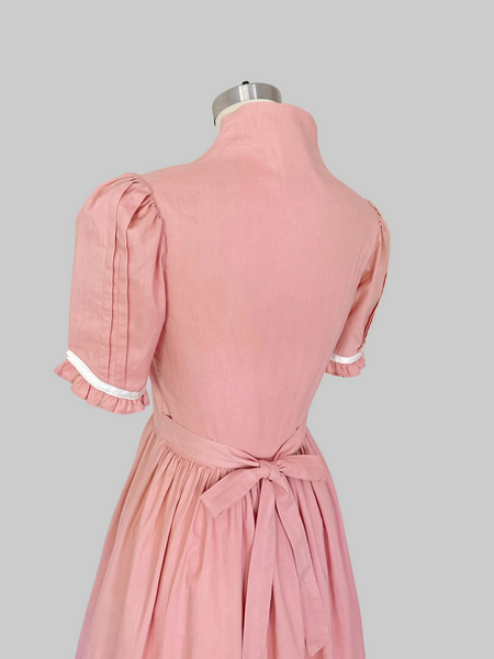 Vintage 1970s Gunne Sax midi dress in rose pink with puffed sleeves, lace trim, and front button closures