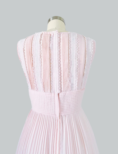 Close view of vintage 1950s L'Aiglon Blush pink Lace trimmed dress with pleated skirt