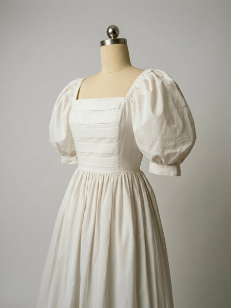1980s Laura Ashley antique white cotton midi dress with pintucked bodice, puff sleeves, square neckline and full skirt, made in Great Britain