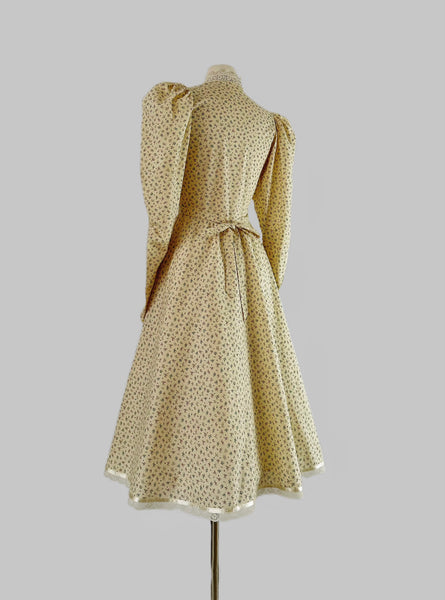 1970s Gunne Sax prairie dress with floral print, high lace collar, button-down front, and dramatic leg-of-mutton puffed sleeves