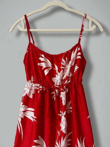 Vintage 1970s / 1980s red dress with large white tropical floral print, spaghetti straps, and an elasticized empire waist with tie detail; maxi length with soft, flowing drape