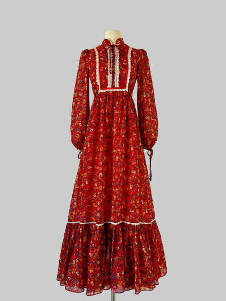 Vintage 1970s red Floral Maxi Bohemian Prairie Dress with lace up bodice and lace trim detailing. 