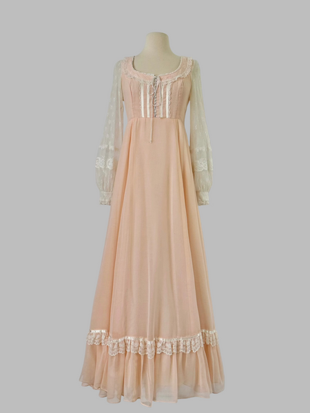 1970s Gunne Sax pastel peach maxi gown with lace-up bodice, pearl beading, high waist, and sheer lace sleeves