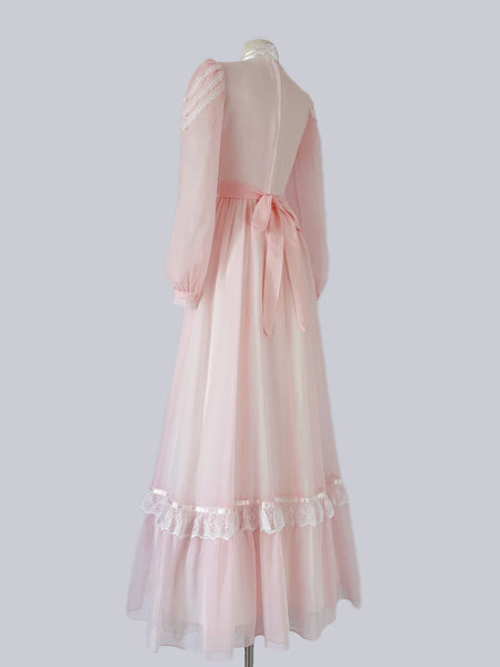 Vintage 1970s Gunne Sax blush pink gown with lace bodice, high Victorian neckline, pearl buttons, and flowing semi-sheer skirt with waist tie
