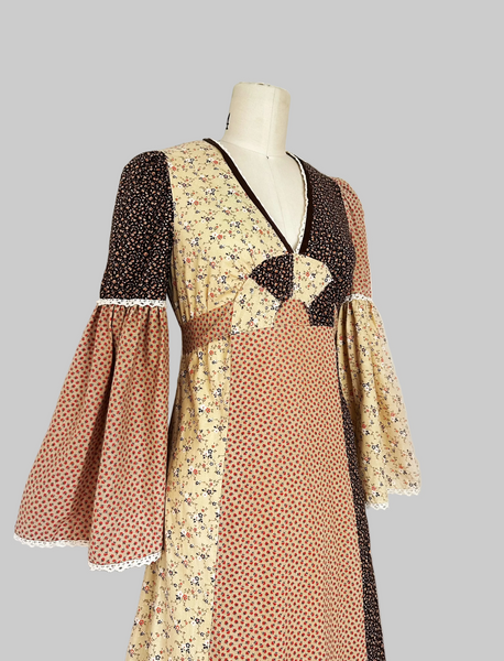 1970s Trivia by Charm of Hollywood patchwork maxi dress in chocolate brown, beige, and butter yellow with mixed ditsy floral prints, long bell sleeves, and ruffled hem.