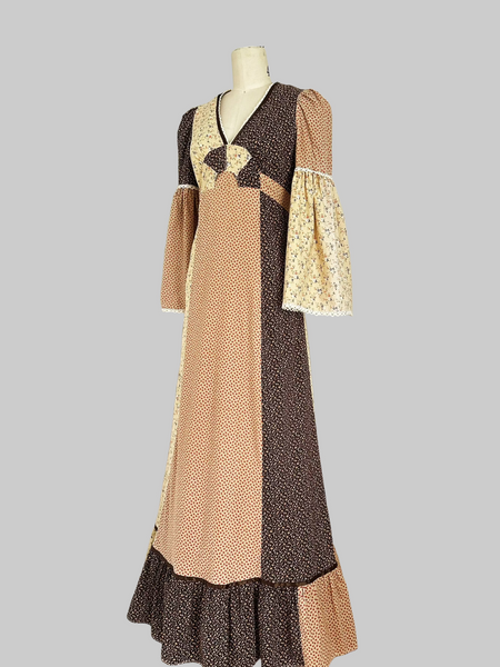 1970s Trivia by Charm of Hollywood patchwork maxi dress in chocolate brown, beige, and butter yellow with mixed ditsy floral prints, long bell sleeves, and ruffled hem.