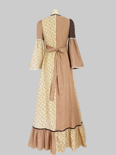 1970s Trivia by Charm of Hollywood patchwork maxi dress in chocolate brown, beige, and butter yellow with mixed ditsy floral prints, long bell sleeves, and ruffled hem.