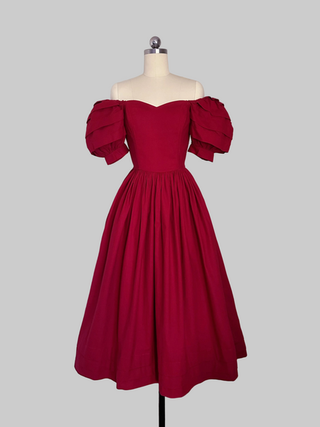 1980s Laura Ashley Red  cotton dress with a fitted boned sweetheart bodice, tiered puff sleeves, and full sweeping skirt