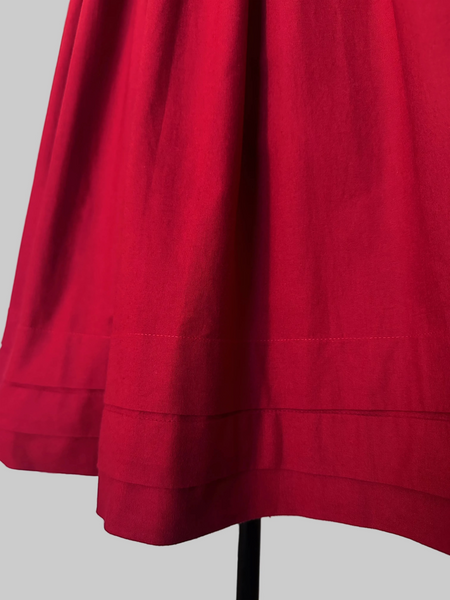 A close-up of 1980s Laura Ashley cotton dress with a fitted boned sweetheart bodice, tiered puff sleeves, and full sweeping skirt