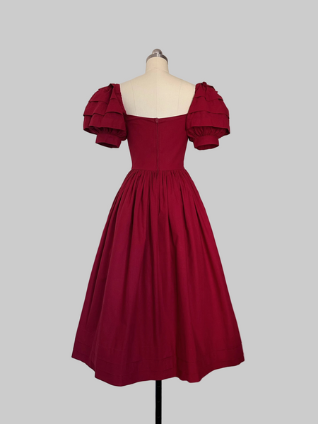 Back view of 1980s Laura Ashley cotton Red  dress with a fitted boned sweetheart bodice, tiered puff sleeves, and full sweeping skirt