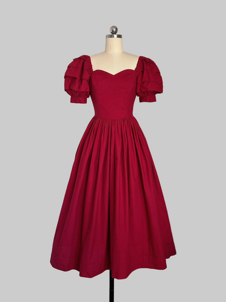 1980s Laura Ashley  Red cotton dress with a fitted boned sweetheart bodice, tiered puff sleeves, and full sweeping skirt