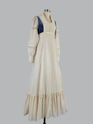Vintage 1970s Gunne Sax prairie maxi dress featuring natural cream cotton fabric with blue velvet accents, embodying classic bohemian style with a flowing silhouette and nostalgic charm.
