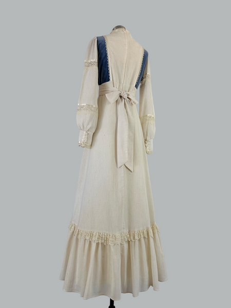 Vintage 1970s Gunne Sax prairie maxi dress featuring natural cream cotton fabric with blue velvet accents, embodying classic bohemian style with a flowing silhouette and nostalgic charm.