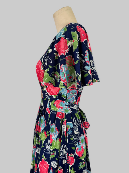Vintage 1970s Jody T California floral print maxi dress featuring a vibrant, bohemian-inspired design with bold floral patterns, flowing silhouette, and retro charm