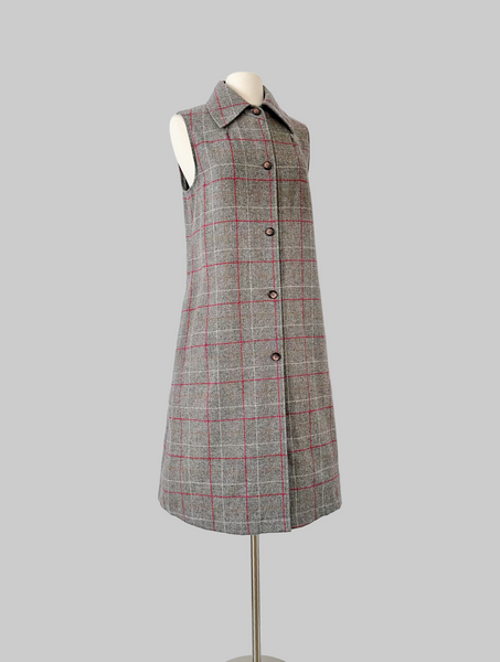 Vintage 1960s sleeveless J. Tiktiner dress made in Nice, France, featuring a gray wool A-line silhouette with red and cream windowpane check, pointed collar, full-length button front, and side seam pockets.