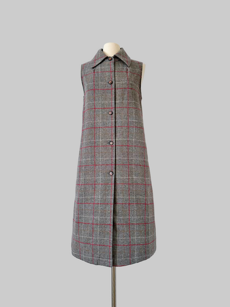Vintage 1960s sleeveless J. Tiktiner dress made in Nice, France, featuring a gray wool A-line silhouette with red and cream windowpane check, pointed collar, full-length button front, and side seam pockets.