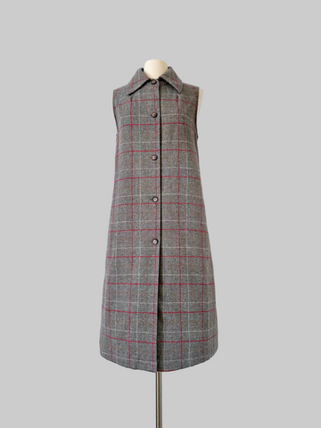 Vintage 1960s sleeveless J. Tiktiner dress made in Nice, France, featuring a gray wool A-line silhouette with red and cream windowpane check, pointed collar, full-length button front, and side seam pockets.