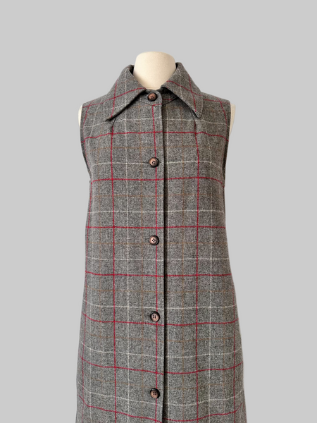 Vintage 1960s sleeveless J. Tiktiner dress made in Nice, France, featuring a gray wool A-line silhouette with red and cream windowpane check, pointed collar, full-length button front, and side seam pockets.