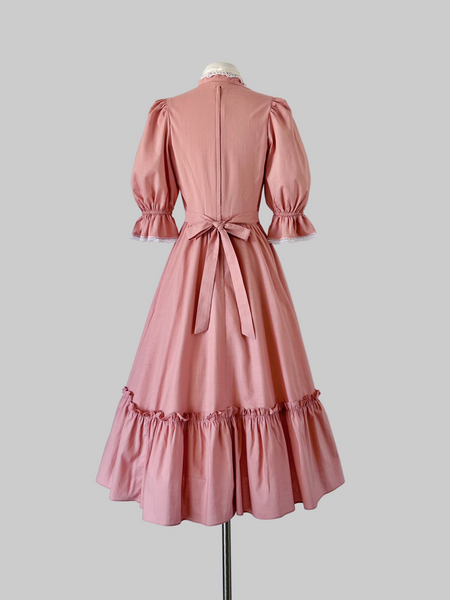  Back view of a 1970s Gunne Sax midi dress with puff sleeves, pearl bead trim, and faux pearl buttons 