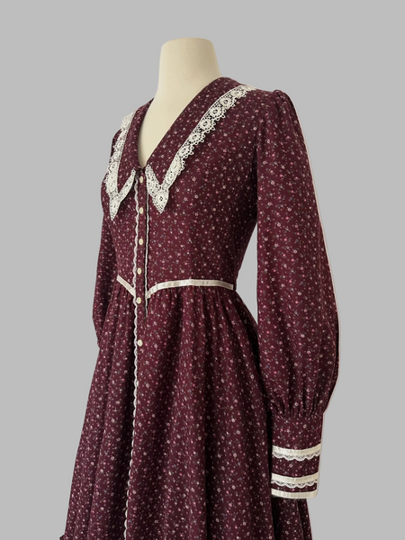 1970s Burgundy vintage Gunne Sax dress with a floral print and a white lace-trimmed collar.