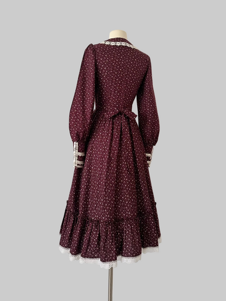 1970s Burgundy vintage Gunne Sax dress with a floral print and a white lace-trimmed collar.