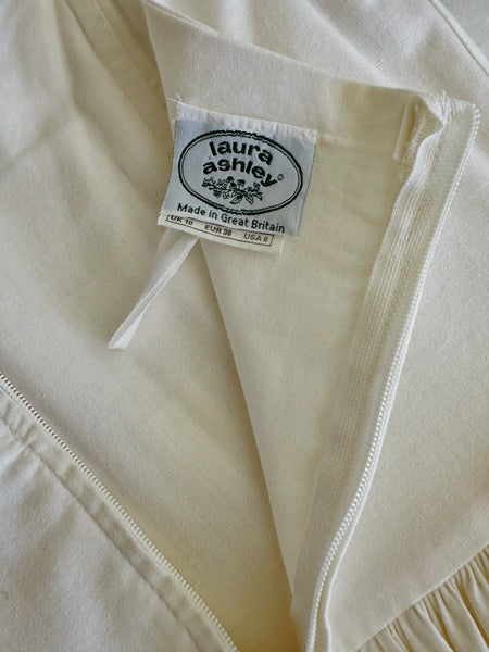 1980s Laura Ashley antique white cotton midi dress with pintucked bodice, puff sleeves, square neckline and full skirt, made in Great Britain