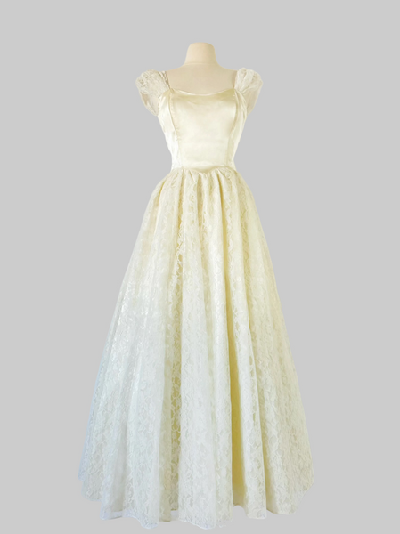 1980s bridal gown, Gunne Sax dress, vintage wedding dress, ivory wedding gown, minimalist bridal, satin bodice dress, open back gown, lace wedding dress, romantic bridal, prairie bridal, boho wedding dress, vintage bride, 80s wedding gown, full length gown, layered skirt dress, crinoline skirt, cottagecore bridal, ethereal wedding dress, classic bridal style, timeless wedding gown