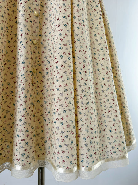 1970s Gunne Sax prairie dress with floral print, high lace collar, button-down front, and dramatic leg-of-mutton puffed sleeves
